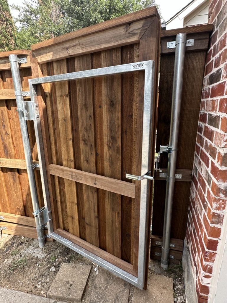 Custom cedar privacy gate with welded steel frame built by Trake