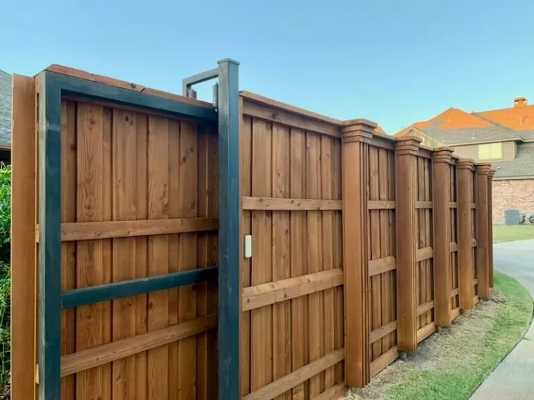 Custom wood privacy fence with metal gate frame installed in Rockwall