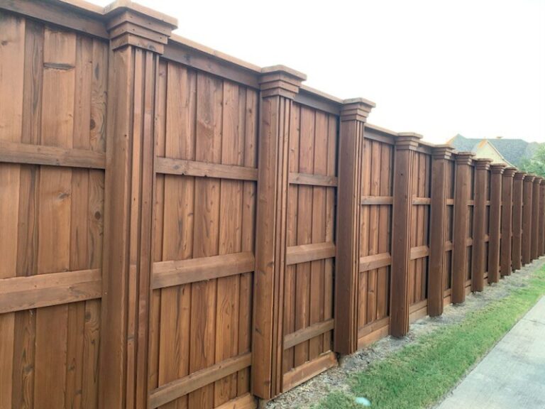 Stained board-on-board wood fence with capped posts in a Rockwall neighborhood