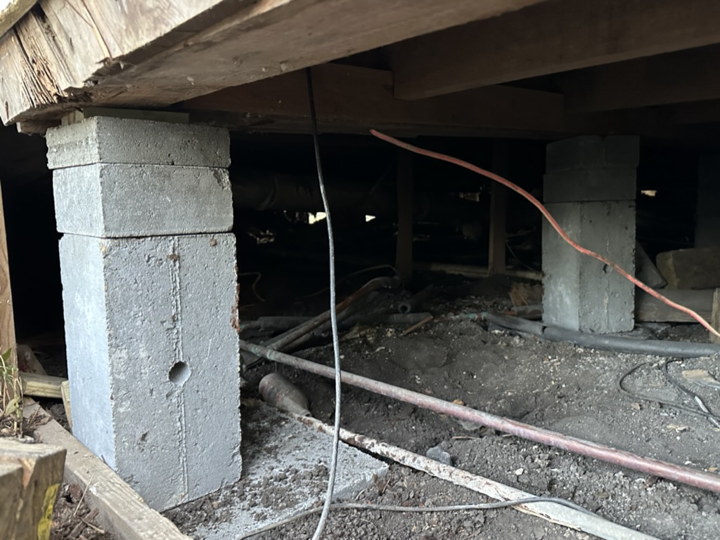 Concrete pier foundation repair under a pier-and-beam home