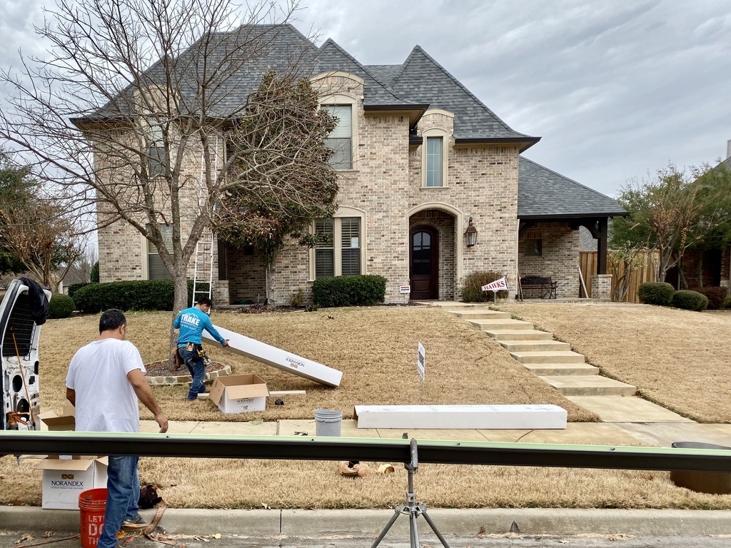 Trake crew installing new seamless gutters on a North Texas home