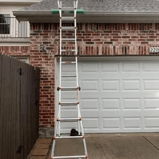 Ladder set up for gutter inspection and repair on a Rockwall home