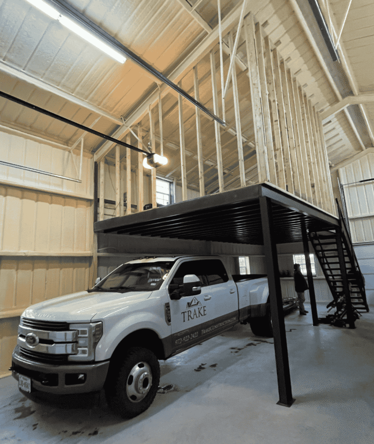Trake Construction truck inside a Rockwall man cave build with framed mezzanine