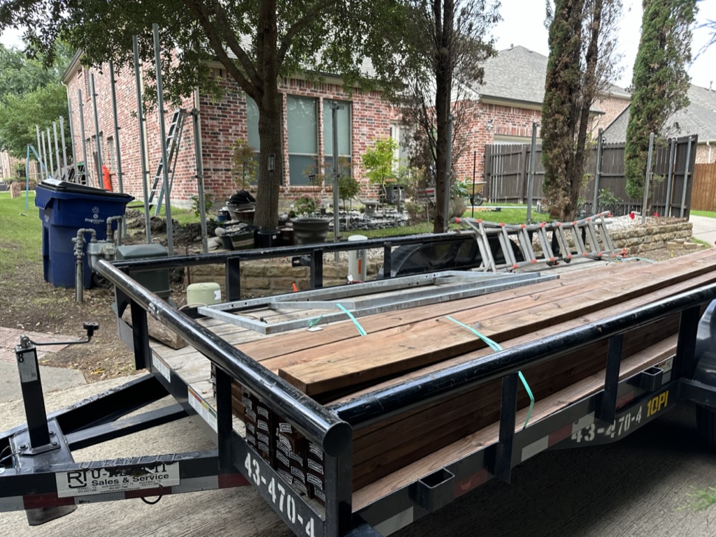 Trake job-site trailer loaded with cedar lumber and ladders