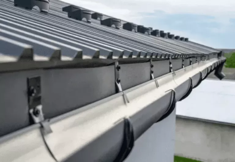 Close-up of newly installed metal roof edge with gutter system