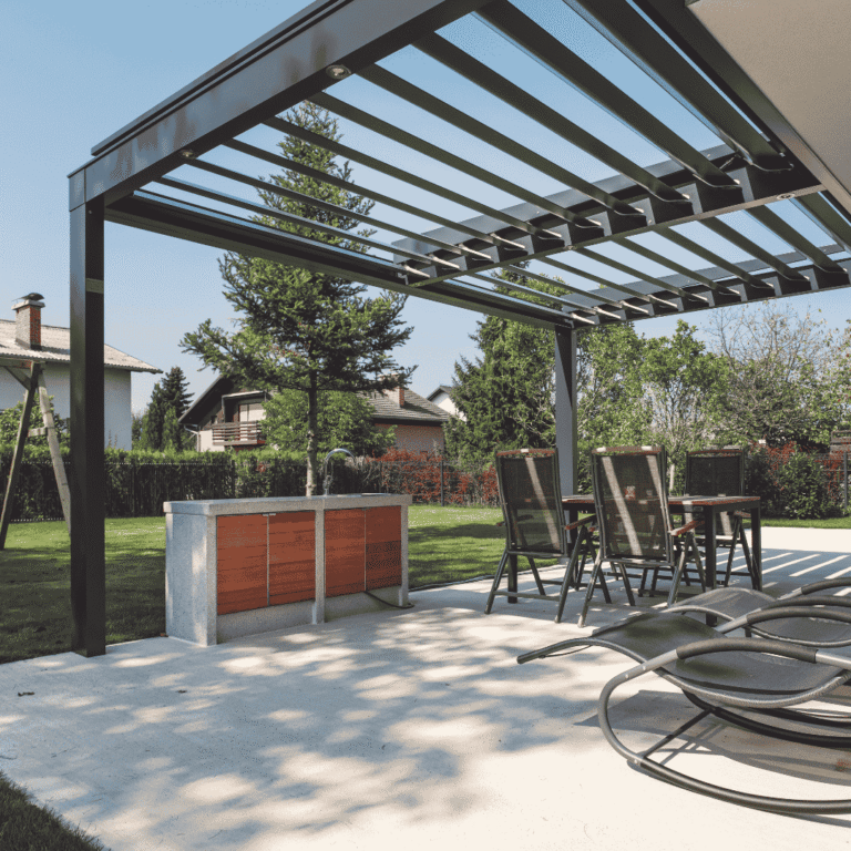 Modern black metal pergola over a backyard patio with outdoor kitchen and seating