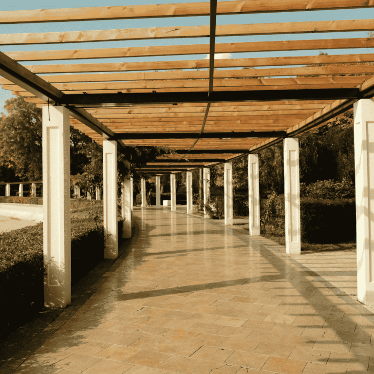 Long wooden pergola with stone columns built for Texas sun and weather conditions