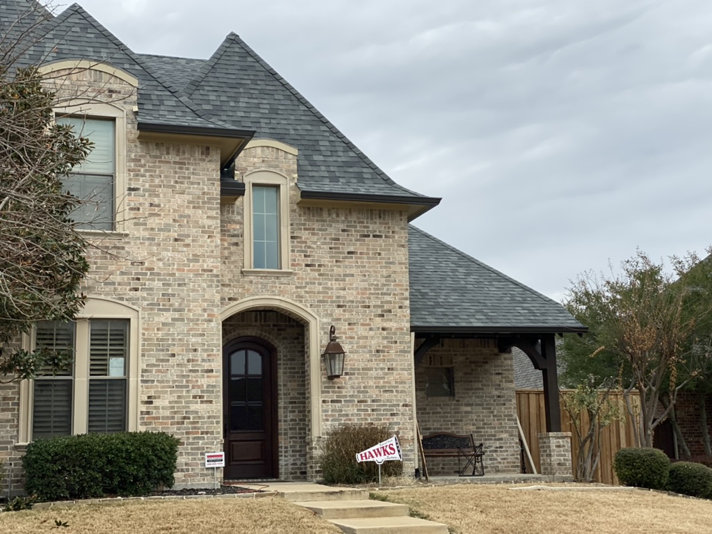 French-style brick home with new architectural shingle roof