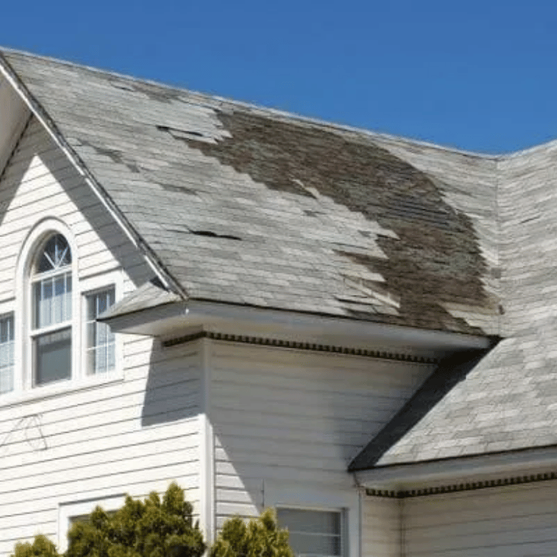Storm-damaged shingles peeling off a residential roof in Rockwall, TX