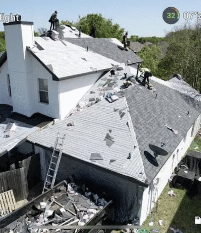 Trake Construction crew tearing off and replacing a residential-style roof in Rockwall