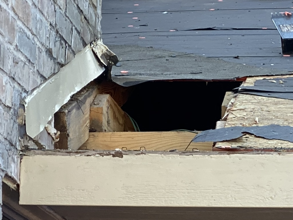 Storm-damaged roof decking exposed during a Trake tear-off and repair